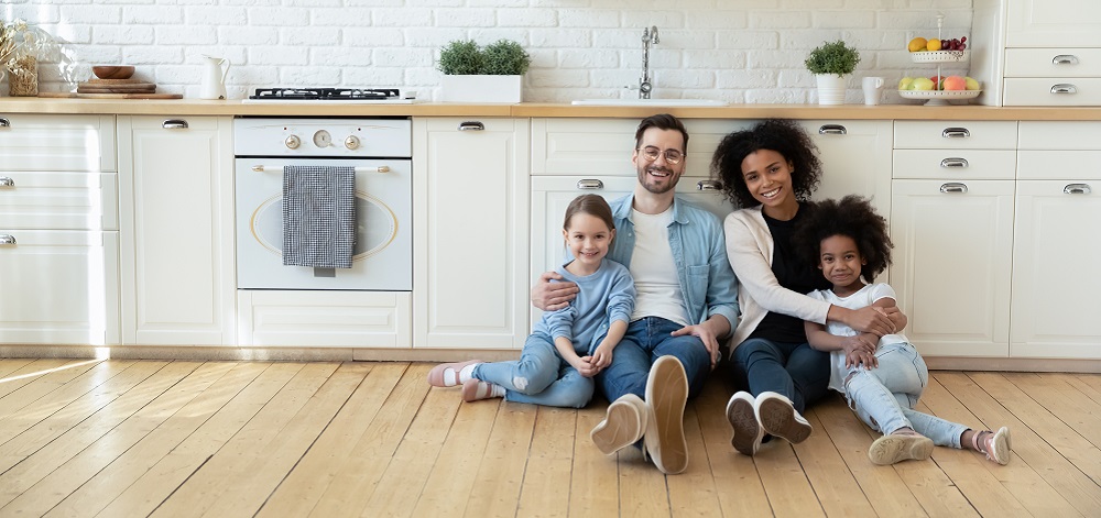 family sitting on kitchen floor